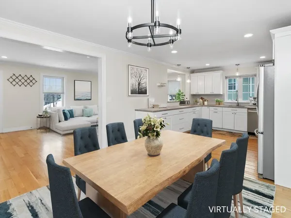 a kitchen with stainless steel appliances kitchen island granite countertop a dining table and chairs