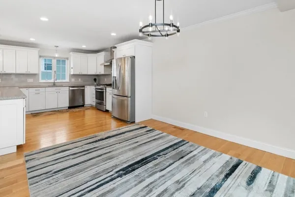 a kitchen with stainless steel appliances granite countertop a refrigerator and a stove top oven