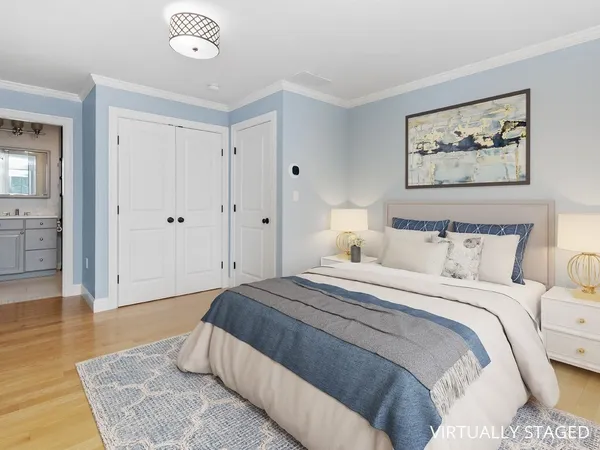 a spacious bedroom with a bed and a chandelier