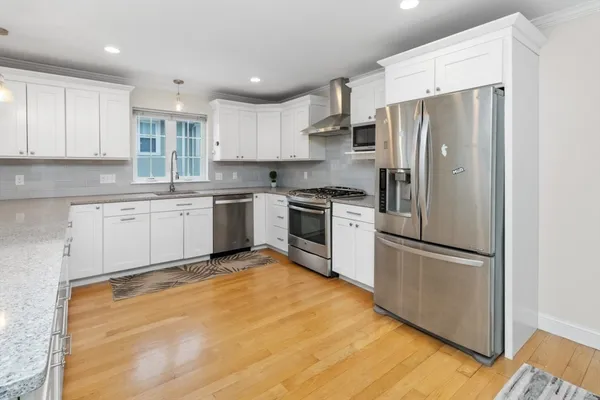 a kitchen with a refrigerator a sink and cabinets