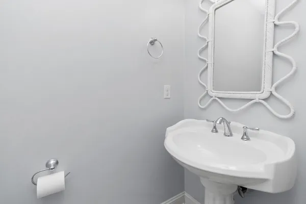 a bathroom with a sink a mirror and a toilet