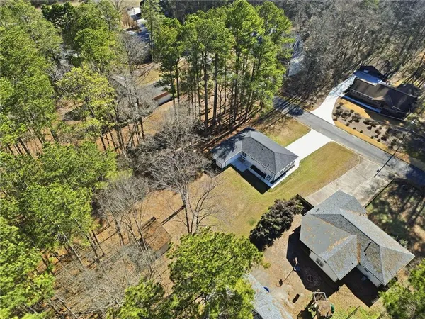 an aerial view of a house with a yard
