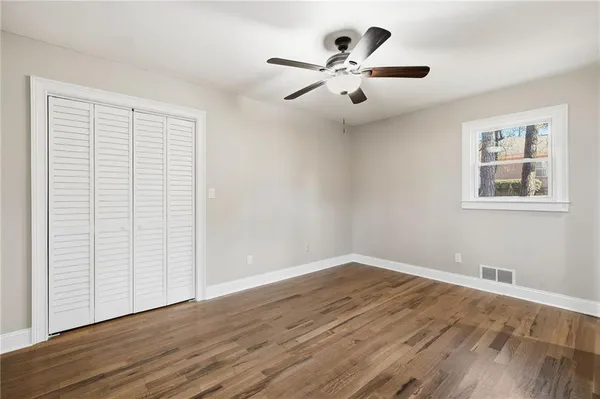 a view of a livingroom with a ceiling fan and wooden floor