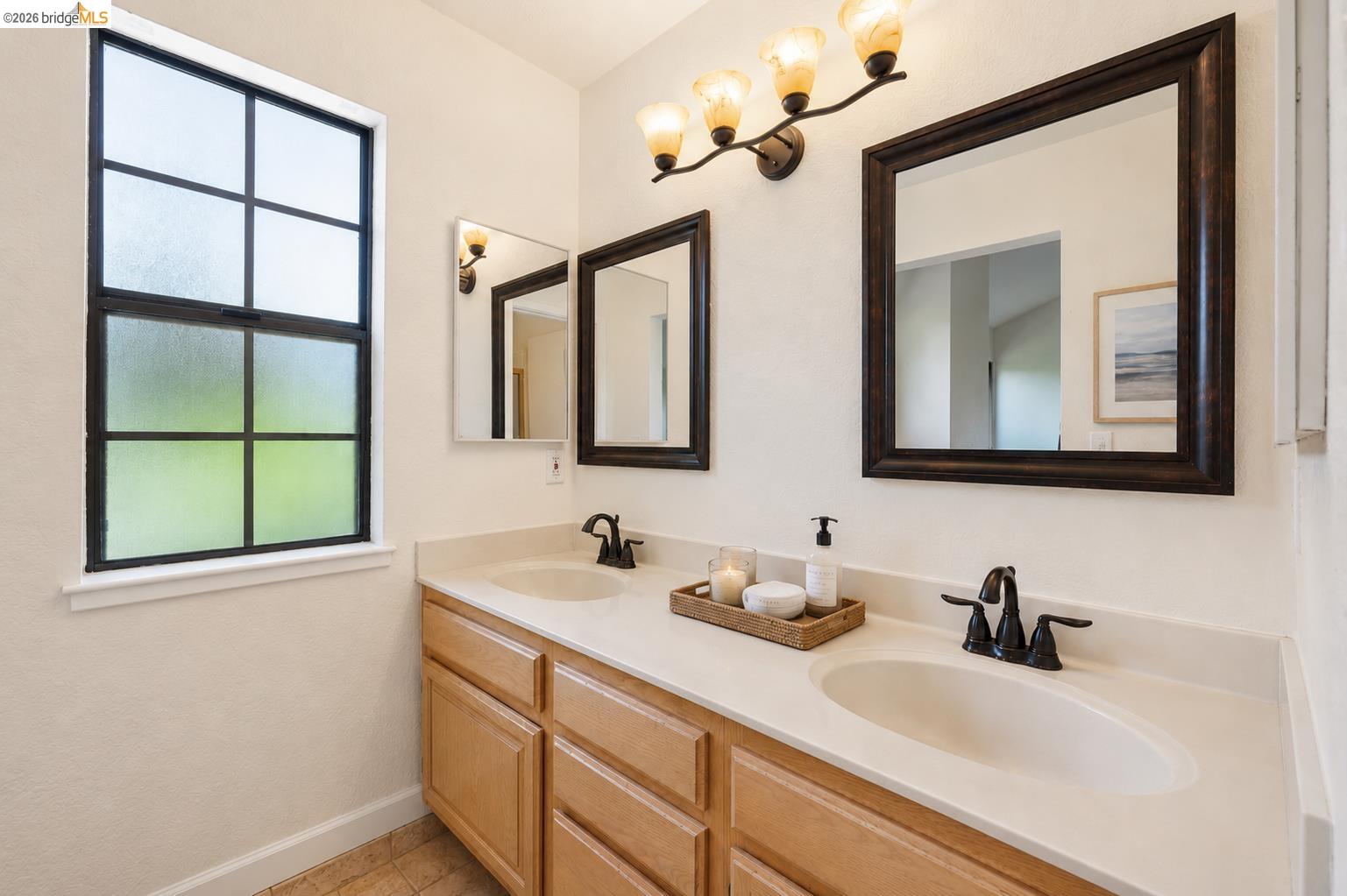 261 Redhawk Road Novato, CA 94949 - Photo 32 of 44 Double vanity with integrated sinks, light-toned countertops, and wood-finish cabinetry