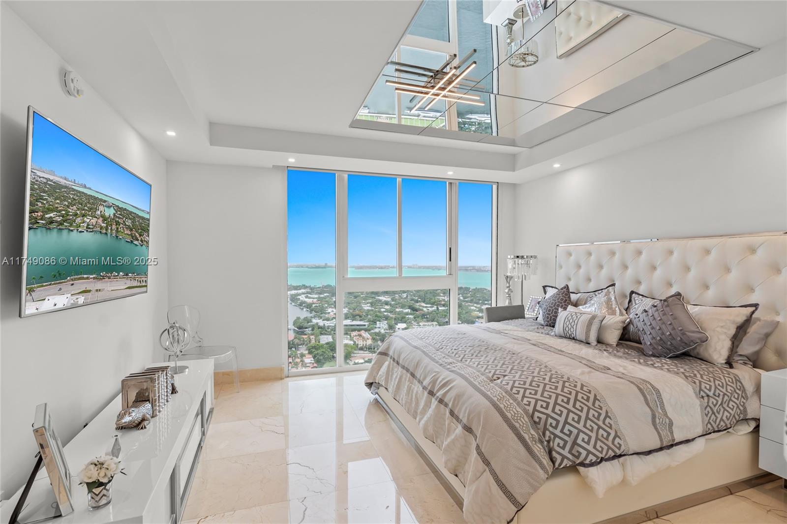 4775 Collins Avenue, Unit 3505 Miami Beach, FL 33140 - Photo 31 of 73 a bedroom with a large bed and a window