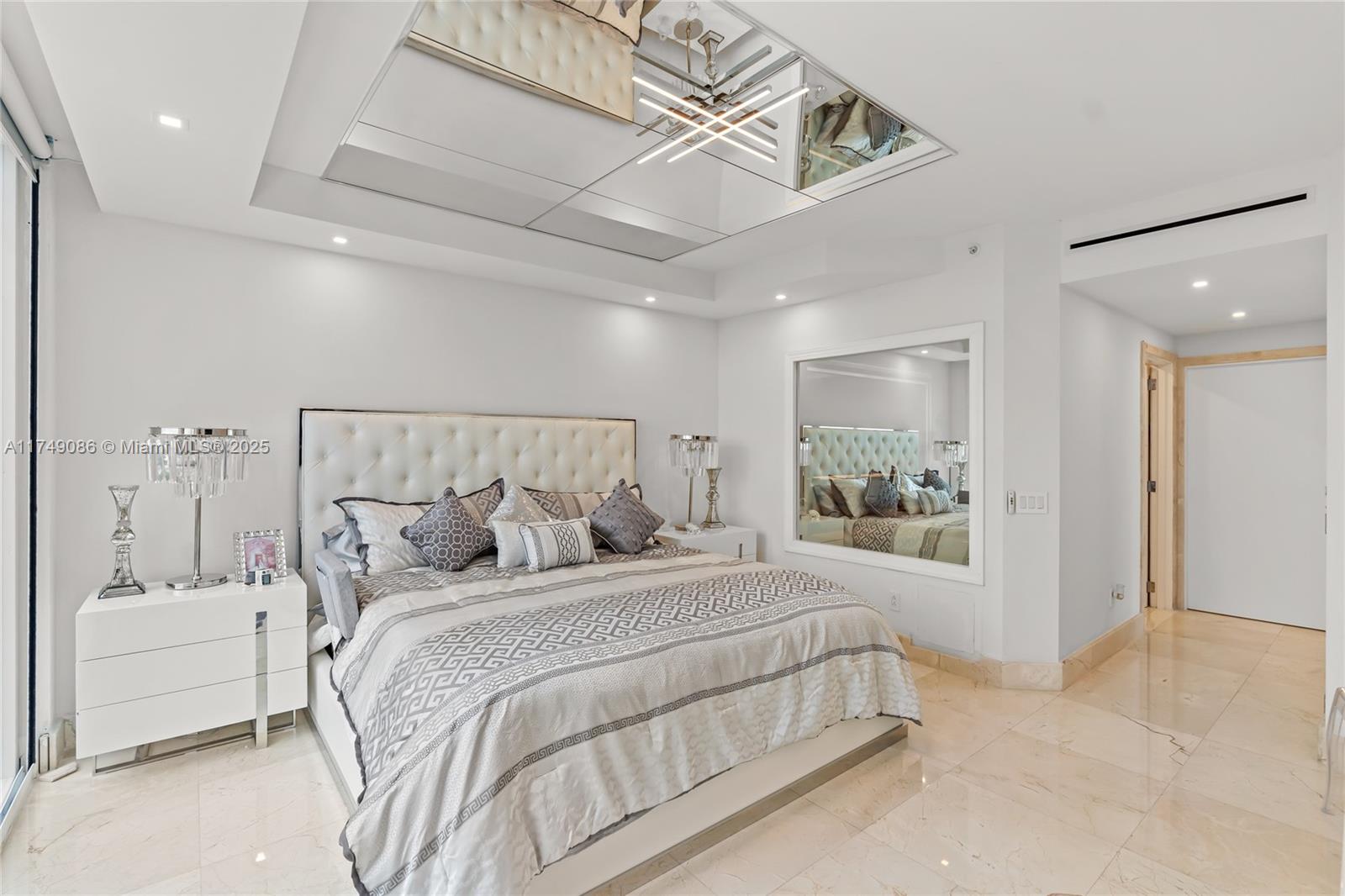 4775 Collins Avenue, Unit 3505 Miami Beach, FL 33140 - Photo 32 of 73 a bedroom with a large bed and a chandelier