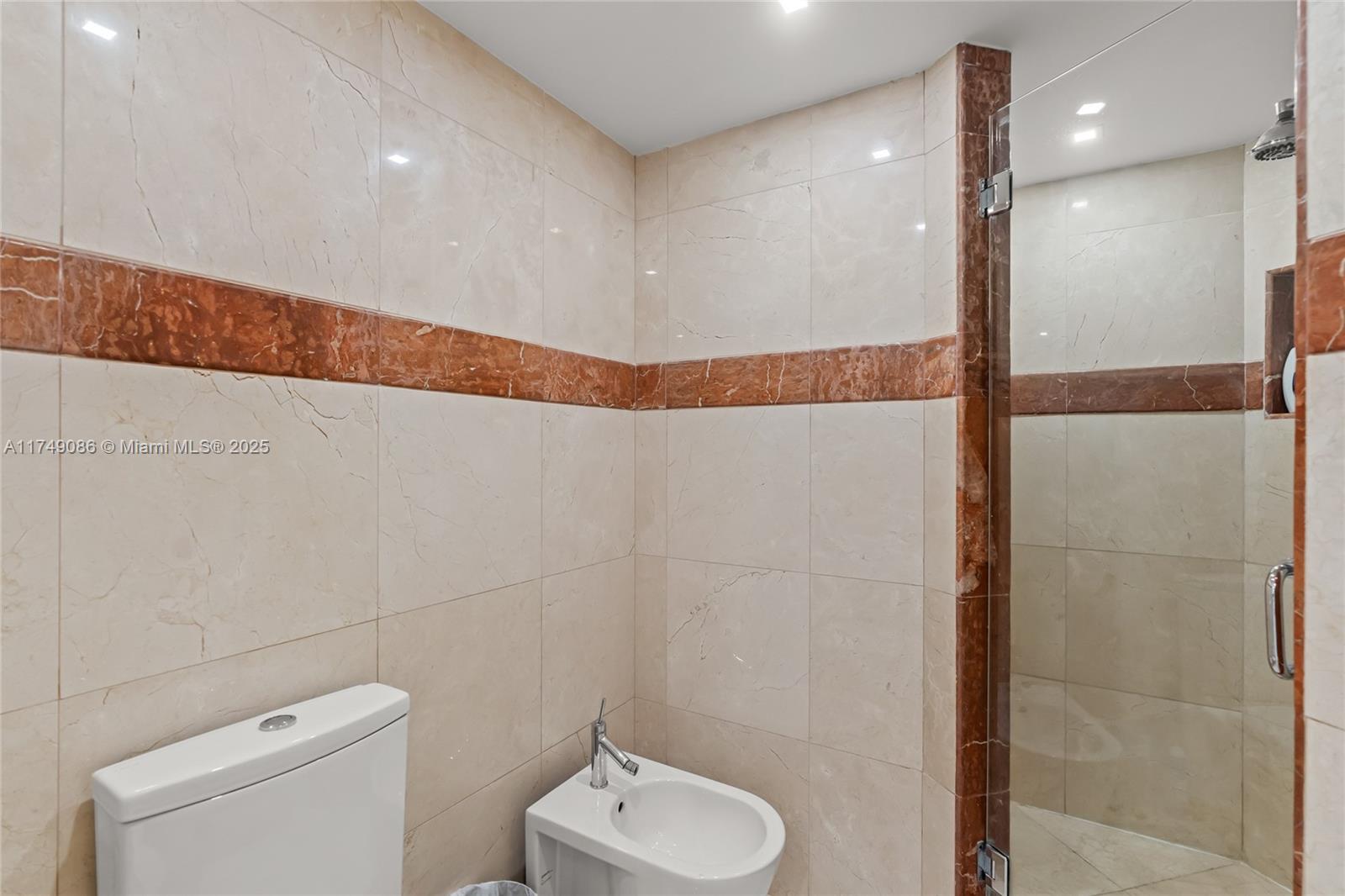 4775 Collins Avenue, Unit 3505 Miami Beach, FL 33140 - Photo 38 of 73 a bathroom with a toilet and a shower