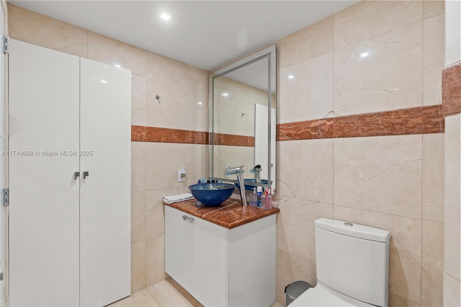 4775 Collins Avenue, Unit 3505 Miami Beach, FL 33140 - Photo 47 of 73 a room with a sink and cabinets