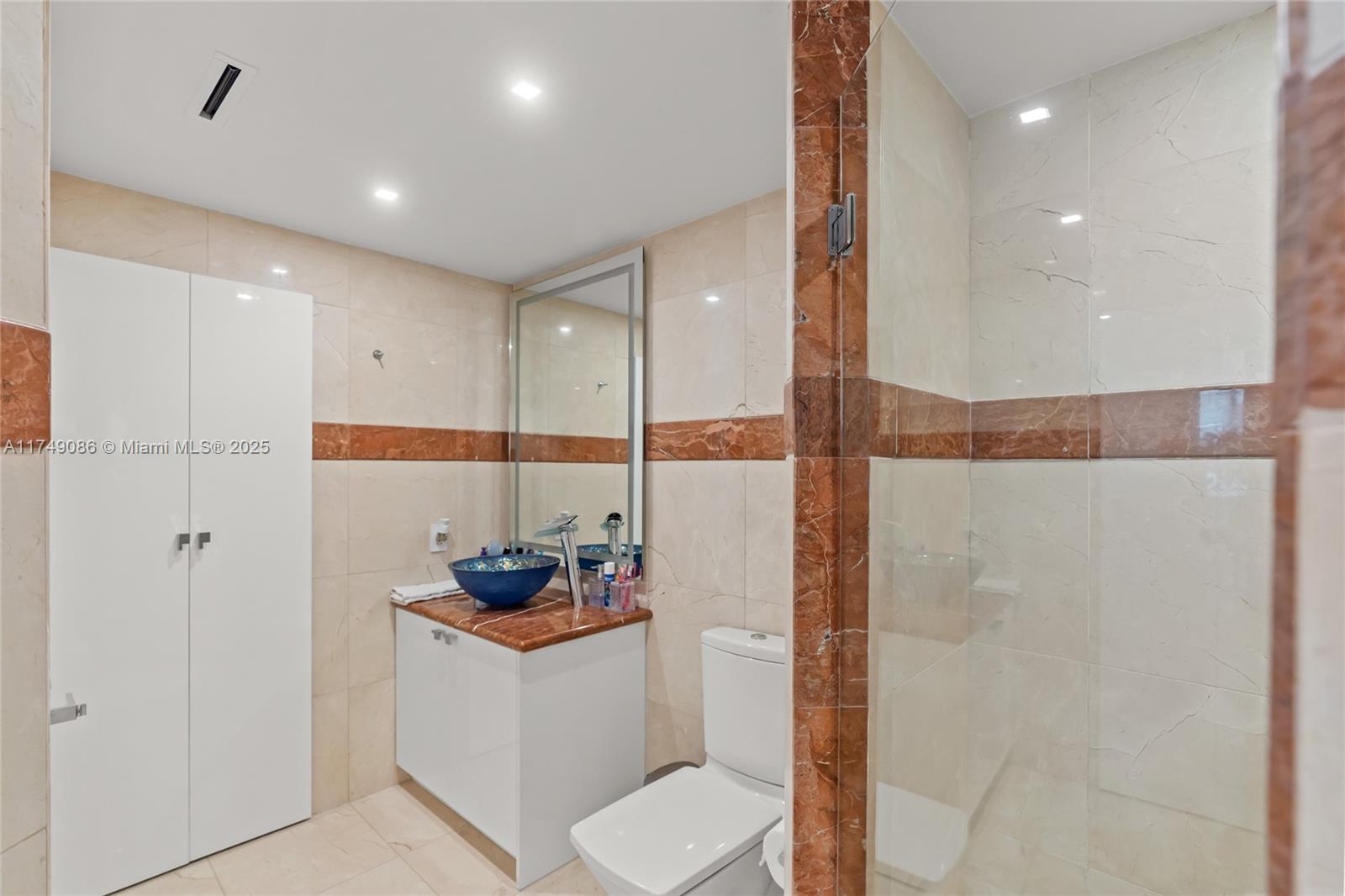 4775 Collins Avenue, Unit 3505 Miami Beach, FL 33140 - Photo 49 of 73 a bathroom with a toilet and a shower