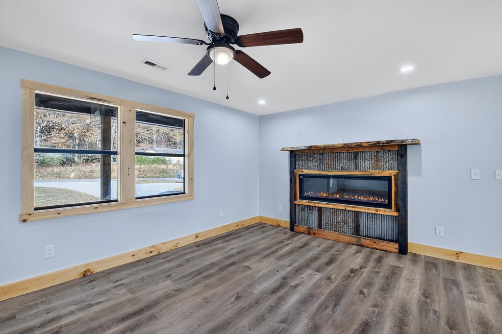 569 No 20 Mine Road McCaysville, GA 30555 - Photo 13 of 29 an empty room with windows chandelier fan and windows