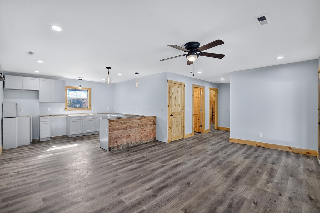 569 No 20 Mine Road McCaysville, GA 30555 - Photo 15 of 29 a view of a kitchen with wooden floor and a ceiling fan