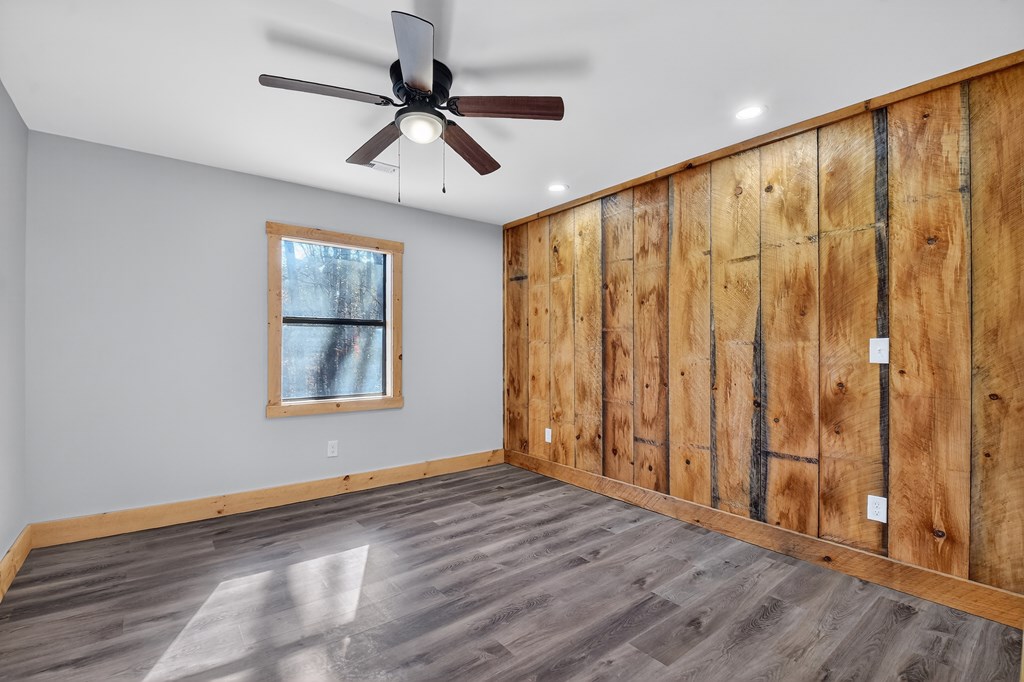 569 No 20 Mine Road McCaysville, GA 30555 - Photo 17 of 29 an empty room with wooden floor fan and windows