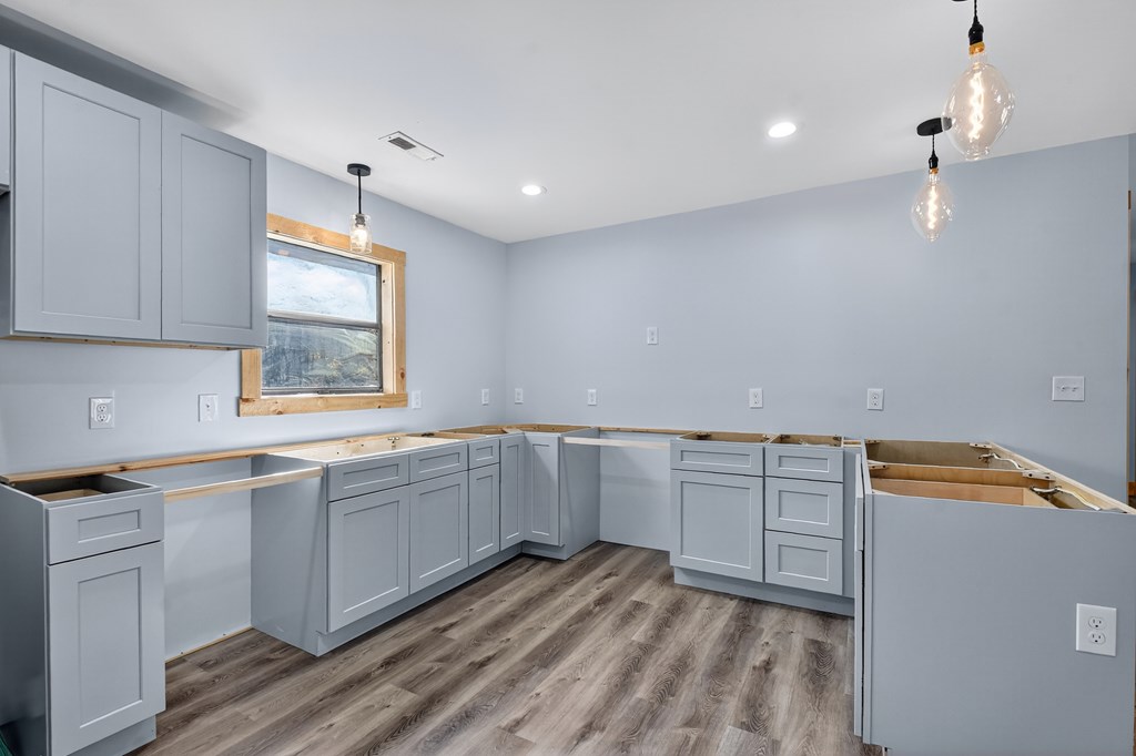 569 No 20 Mine Road McCaysville, GA 30555 - Photo 2 of 29 a kitchen with white cabinets and sink