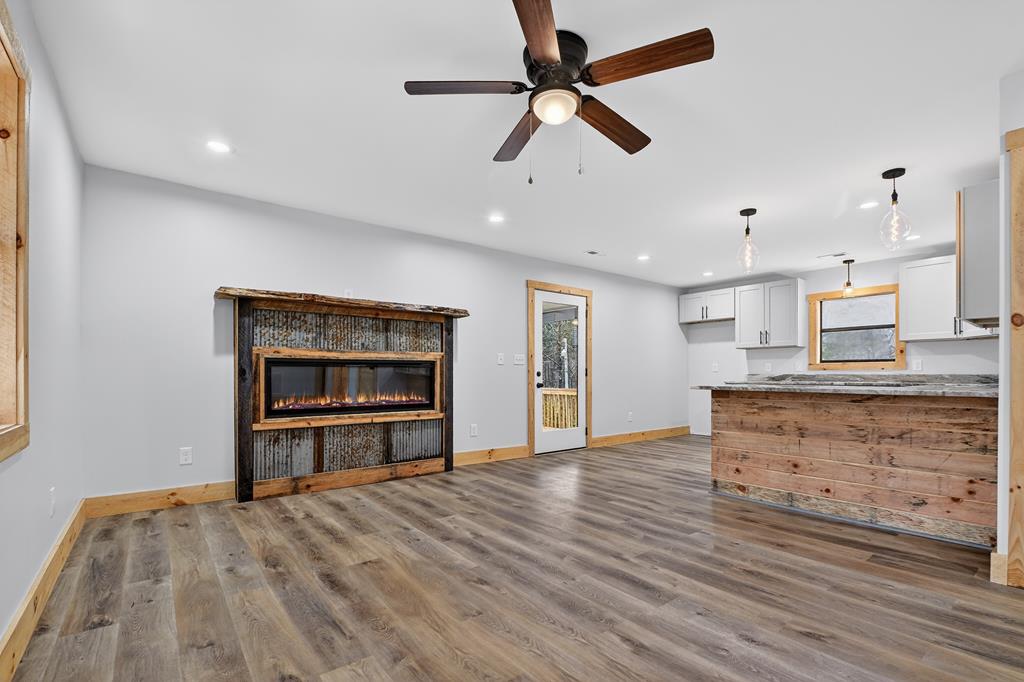 569 No 20 Mine Road McCaysville, GA 30555 - Photo 27 of 29 a view of kitchen and empty room with wooden floor