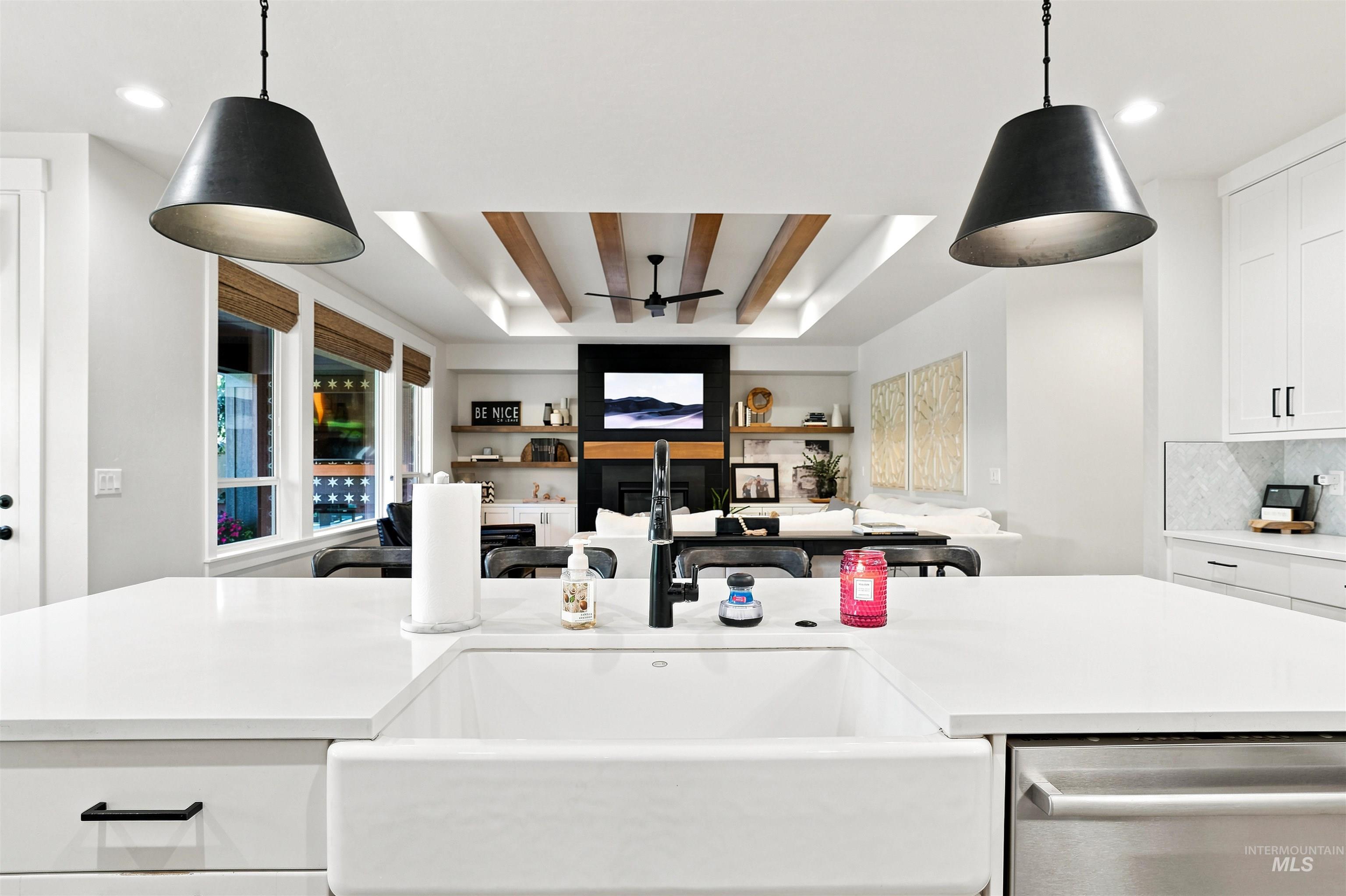 4323 West Ladle Rpds Drive Meridian, ID 83646 - Photo 9 of 49 Kitchen island with a white farmhouse sink, modern pendant lighting, and stainless steel dishwasher