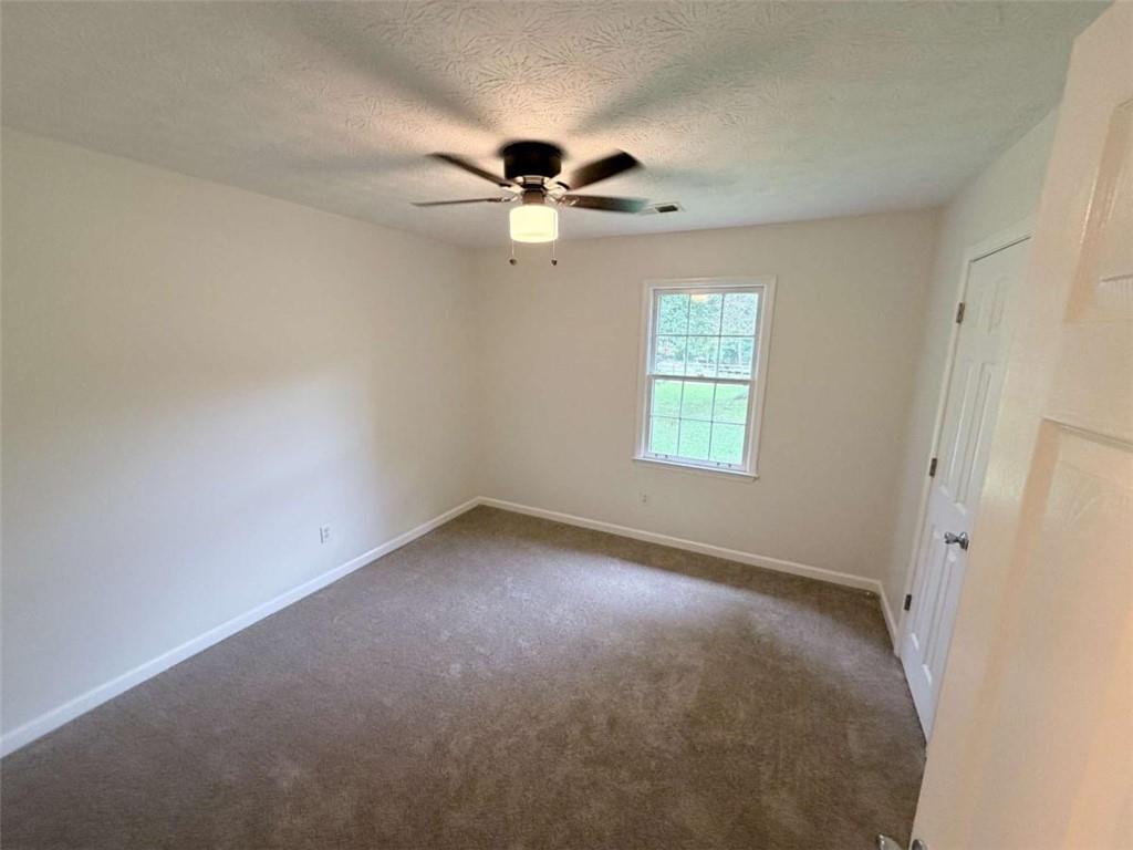 185 Roberts Road Covington, GA 30016 - Photo 15 of 25 an empty room with windows and fan