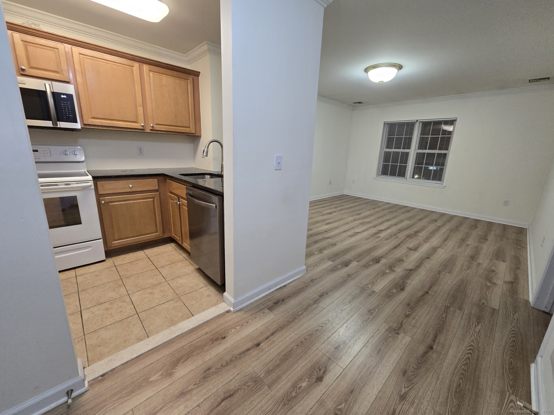 19 Isaacs Street, Unit 406 Norwalk, CT 06850 - Photo 5 of 13 a kitchen with stainless steel appliances granite countertop a stove and a microwave