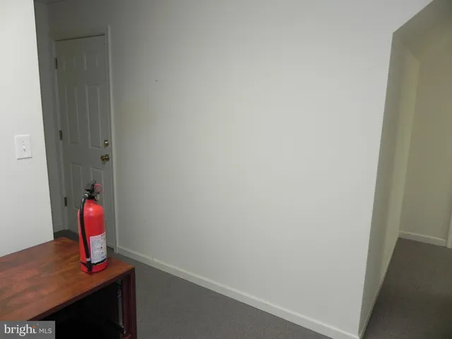 a hallway with a table and a chair