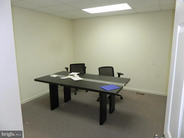 a view of a room with a table and chairs