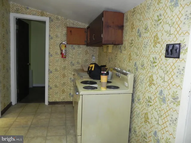 a kitchen with a stove and a refrigerator