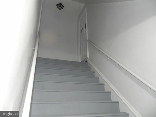 a view of staircase with white walls