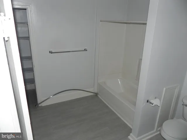 a bathroom with a granite countertop shower and a sink