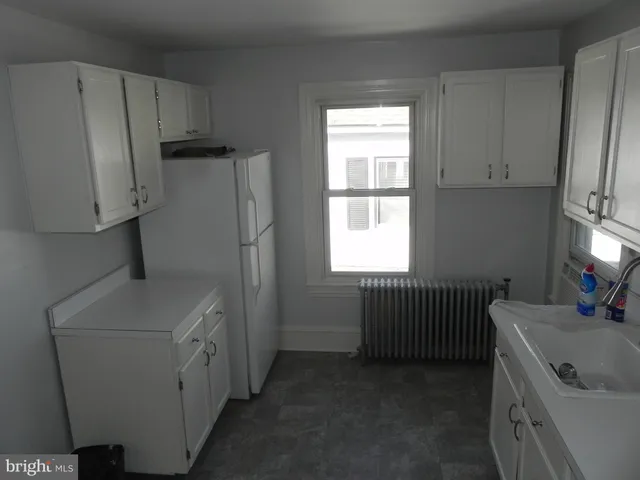 a utility room with cabinets washer and dryer