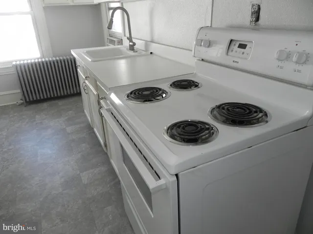 a kitchen with a stove and a refrigerator