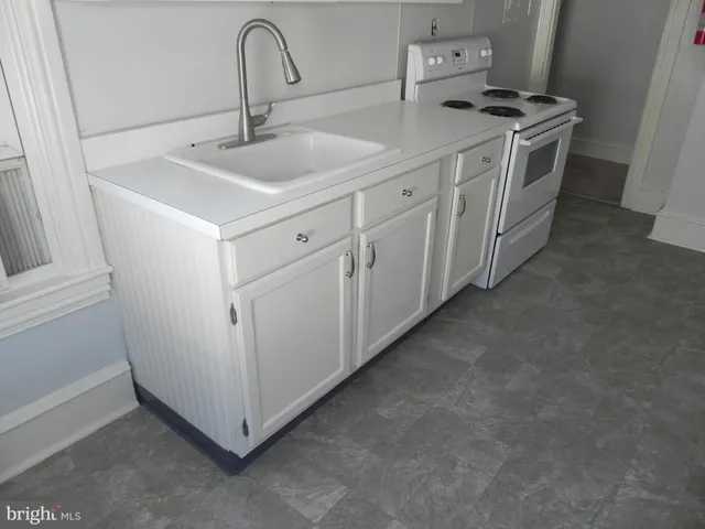 a utility room with sink dryer and washer