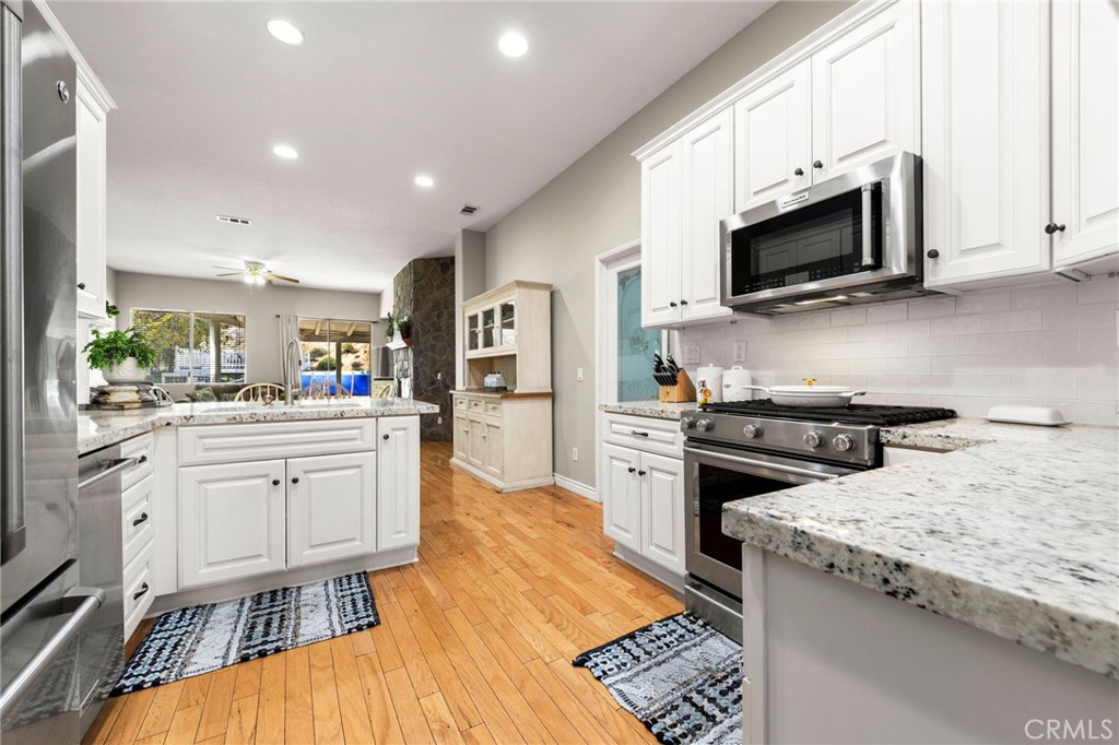 34423 Desert Road Acton, CA 93510 - Photo 15 of 53 a kitchen with white cabinets and appliances
