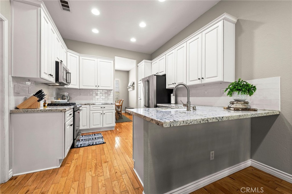 34423 Desert Road Acton, CA 93510 - Photo 16 of 53 a kitchen with kitchen island granite countertop a sink appliances cabinets and a counter top space