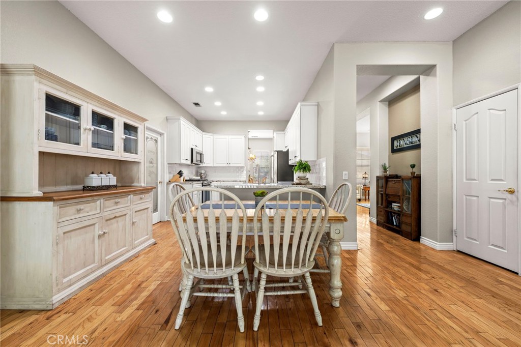 34423 Desert Road Acton, CA 93510 - Photo 20 of 53 a kitchen with stainless steel appliances granite countertop a dining table chairs and wooden floor
