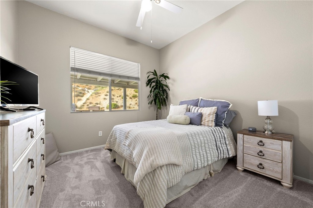 34423 Desert Road Acton, CA 93510 - Photo 28 of 53 a bedroom with a bed and a flat tv screen on dresser