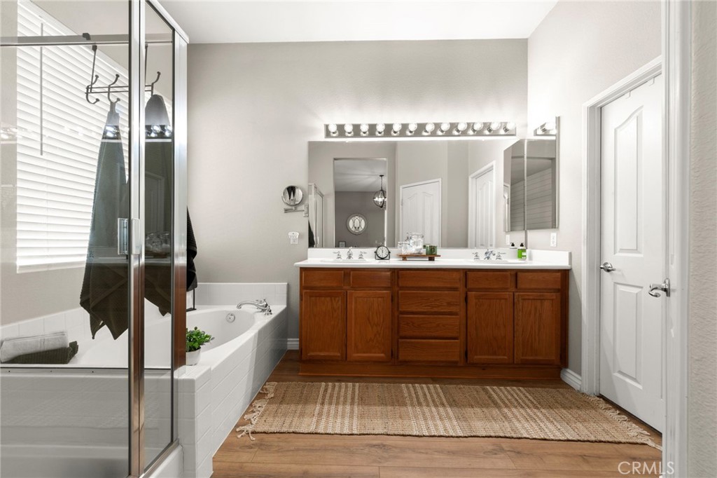 34423 Desert Road Acton, CA 93510 - Photo 34 of 53 a bathroom with a tub a double vanity sink a mirror and a shower