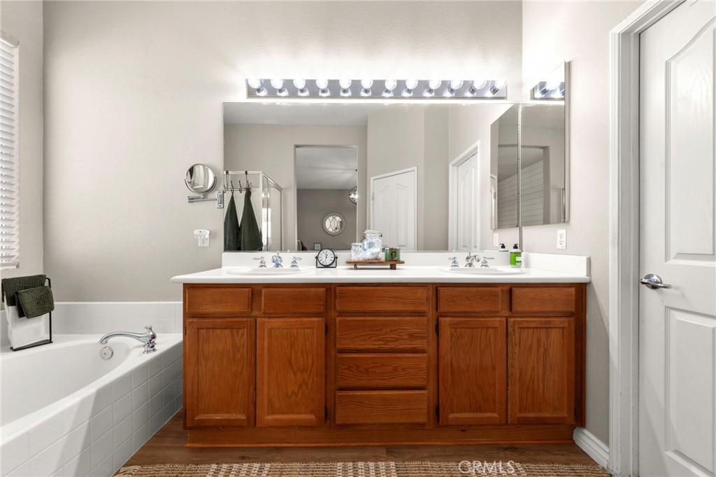34423 Desert Road Acton, CA 93510 - Photo 35 of 53 a bathroom with a double vanity sink mirror and bathtub