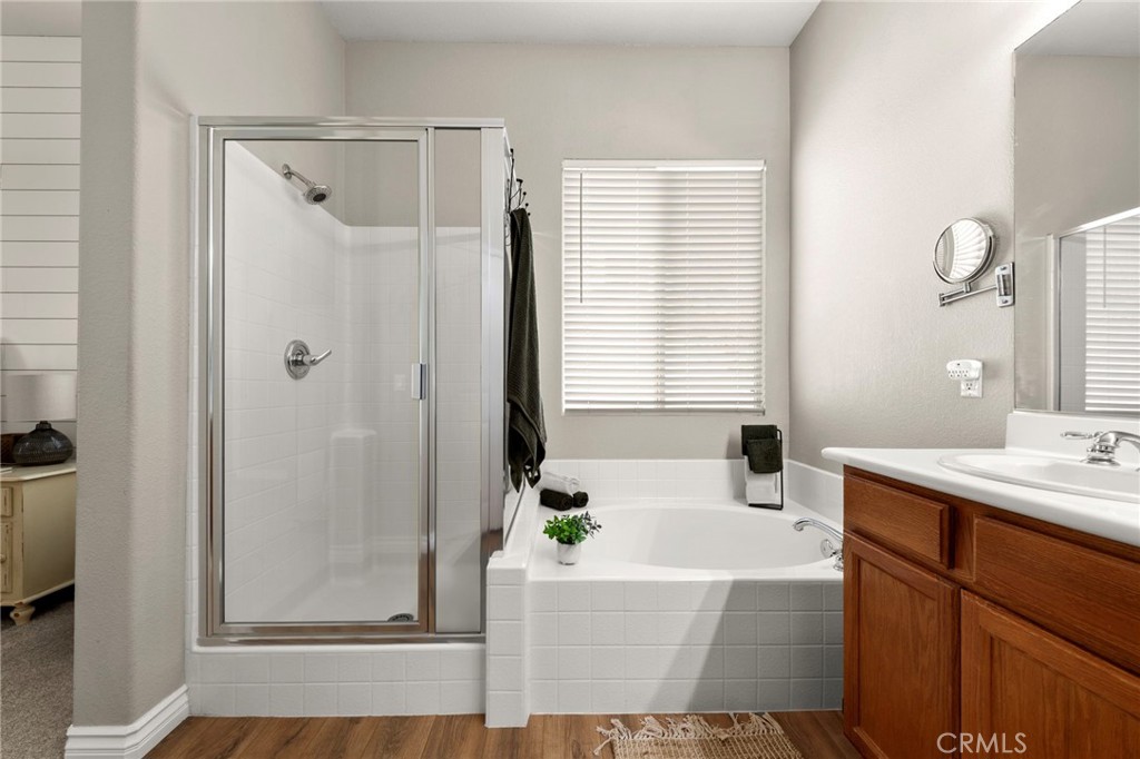 34423 Desert Road Acton, CA 93510 - Photo 36 of 53 a bathroom with a bathtub a shower a sink and a window