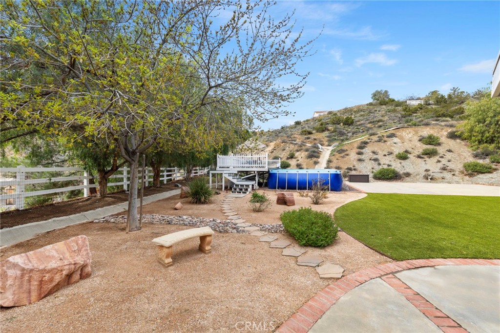 34423 Desert Road Acton, CA 93510 - Photo 41 of 53 a view of a street with a bench and trees around