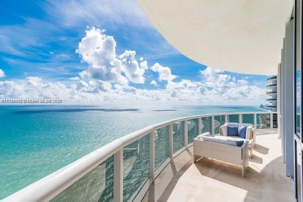 a view of a two chairs in the balcony