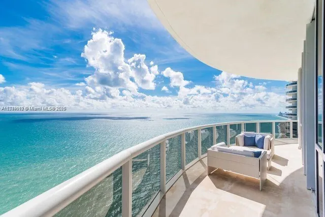 a view of a two chairs in the balcony