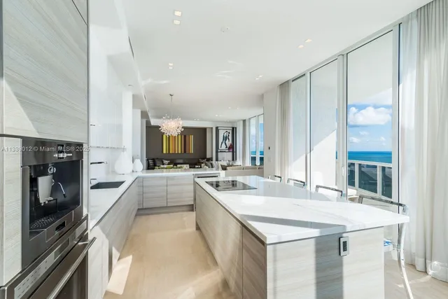 a large white kitchen with a large window