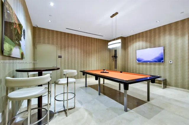 a room with furniture pool table and flat screen tv