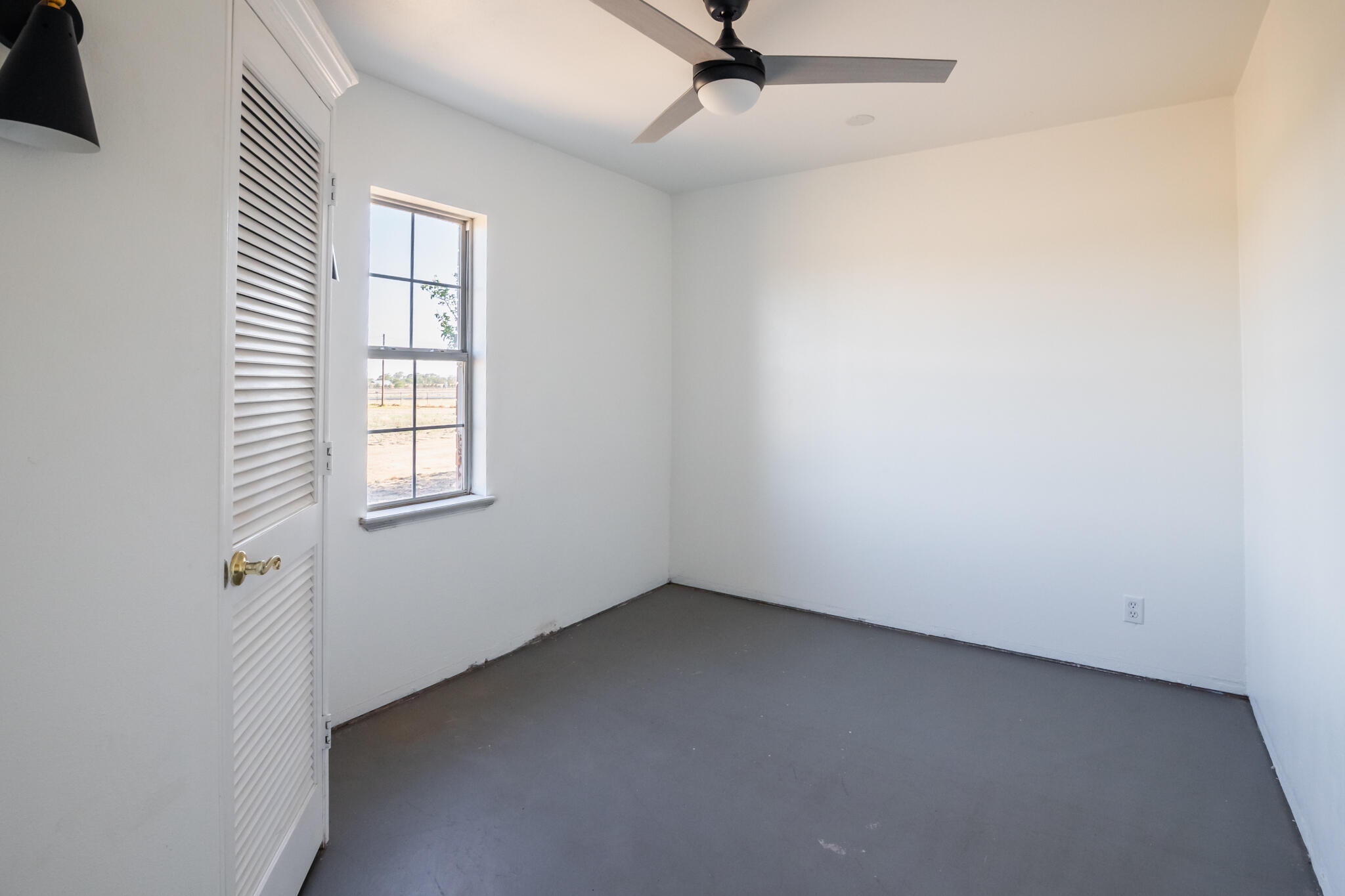 6917 Highway 114 Lubbock, TX 79407 - Photo 13 of 45 an empty room with windows and fan