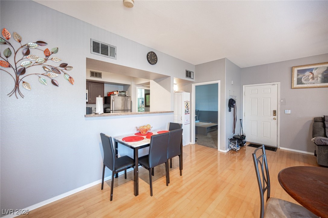 6650 West Warm Springs Road, Unit 1079 Las Vegas, NV 89118 - Photo 11 of 37 Dining room featuring light wood-style floors, visible vents, and baseboards