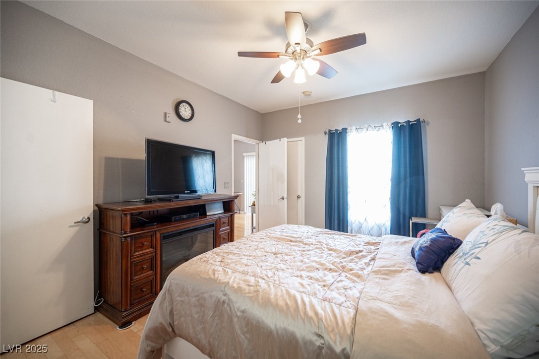 6650 West Warm Springs Road, Unit 1079 Las Vegas, NV 89118 - Photo 21 of 37 Bedroom featuring light wood-style flooring and ceiling fan