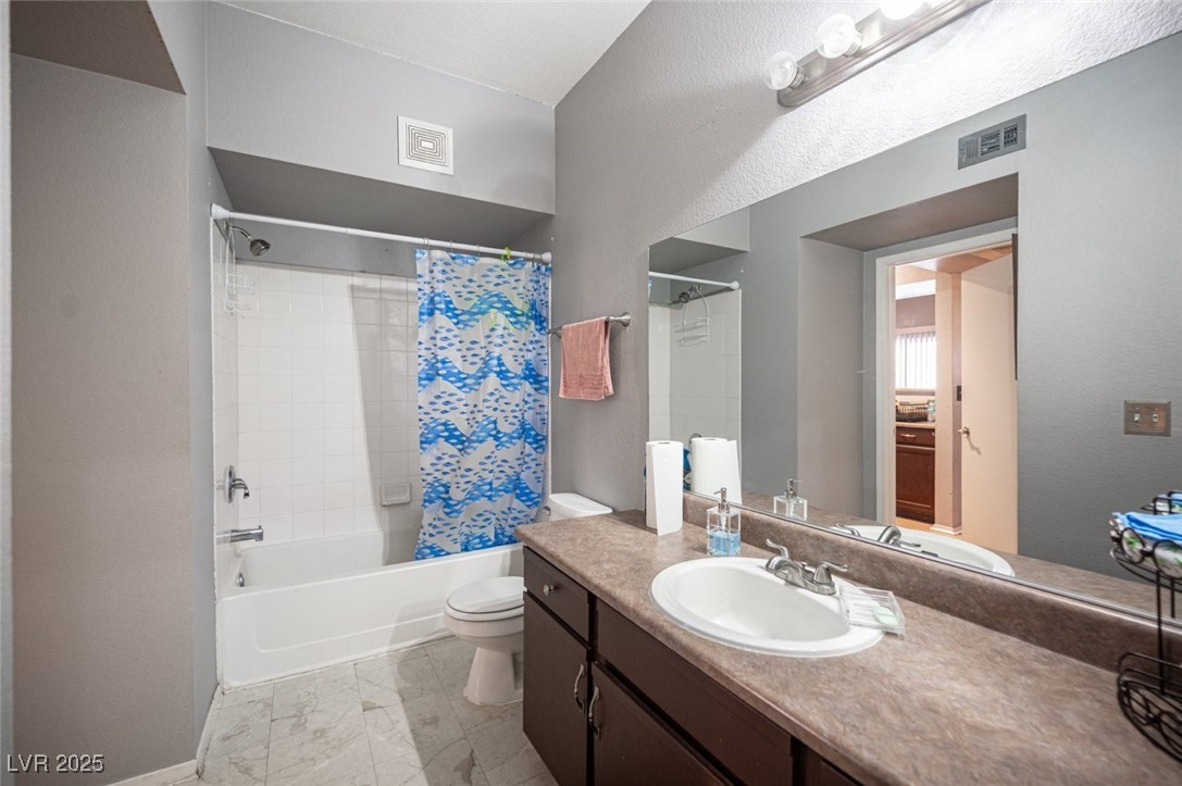 6650 West Warm Springs Road, Unit 1079 Las Vegas, NV 89118 - Photo 28 of 37 Bathroom with toilet, shower / bath combo, vanity, and visible vents