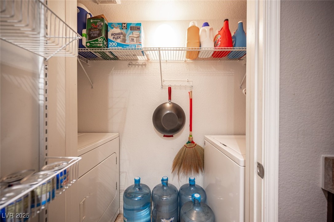 6650 West Warm Springs Road, Unit 1079 Las Vegas, NV 89118 - Photo 29 of 37 Washroom featuring a textured wall, washing machine and dryer, and laundry area
