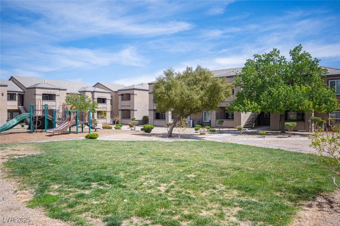 6650 West Warm Springs Road, Unit 1079 Las Vegas, NV 89118 - Photo 33 of 37 View of community with playground community, a residential view, and a lawn