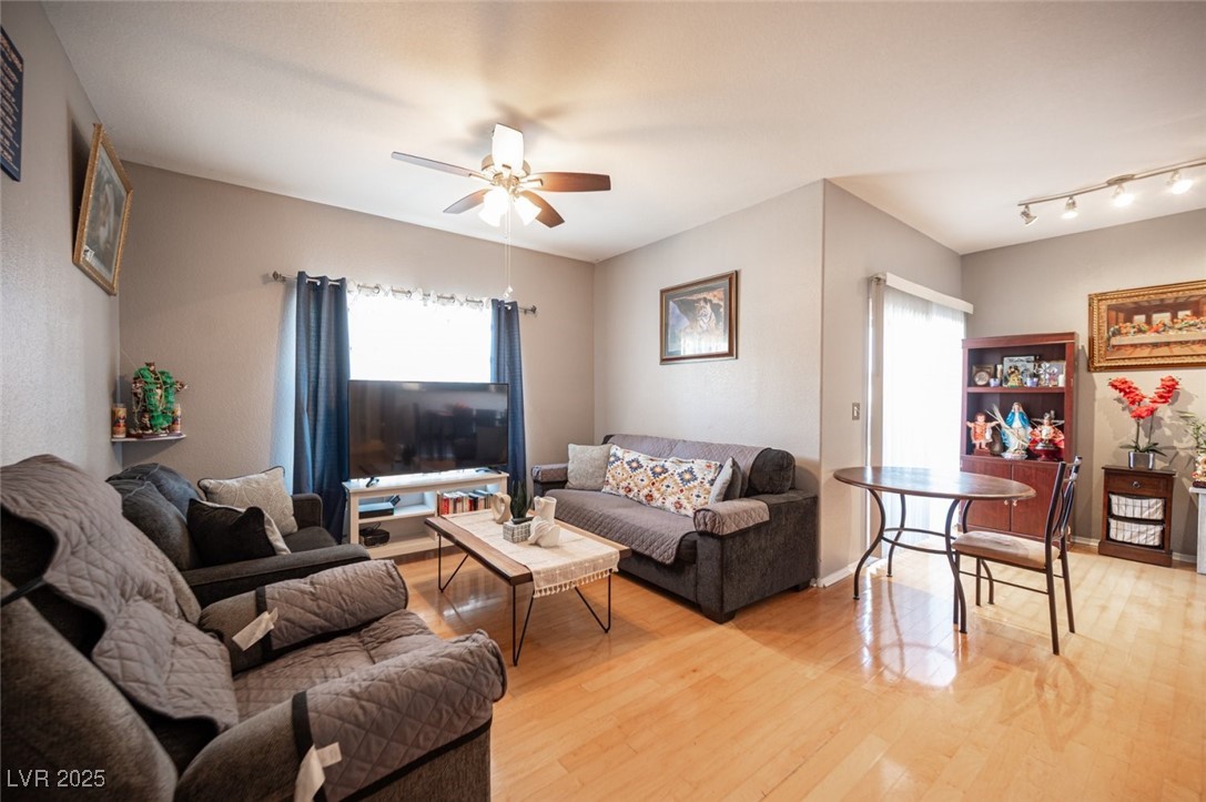 6650 West Warm Springs Road, Unit 1079 Las Vegas, NV 89118 - Photo 4 of 37 Living area featuring ceiling fan, light wood-type flooring, and baseboards