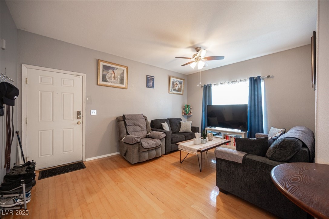 6650 West Warm Springs Road, Unit 1079 Las Vegas, NV 89118 - Photo 5 of 37 Living room with light wood-type flooring, ceiling fan, and baseboards
