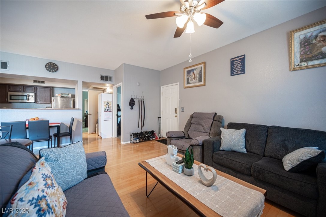 6650 West Warm Springs Road, Unit 1079 Las Vegas, NV 89118 - Photo 7 of 37 Living room with visible vents, ceiling fan, and light wood finished floors